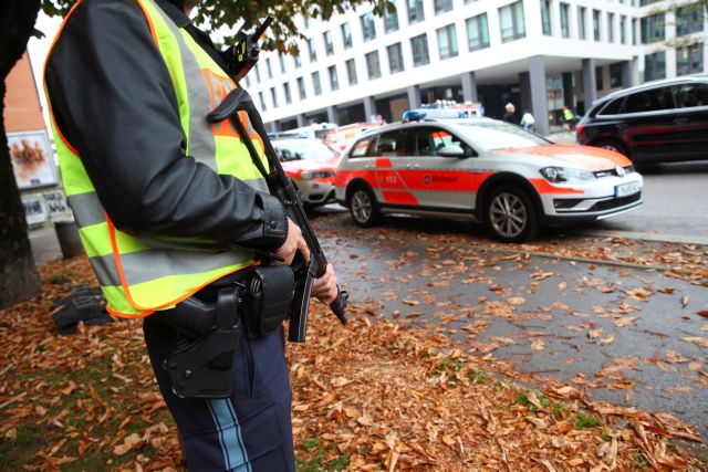 A German police officer guards the site where earlier a man injured several people in a knife attack in Munich
