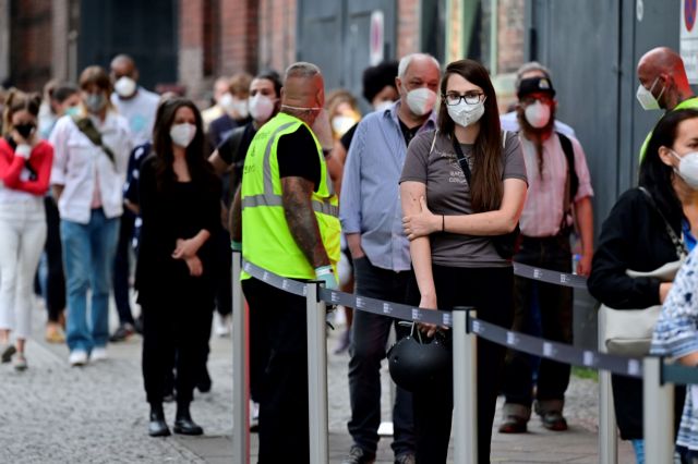 People queue to receive a vaccine against the coronavirus disease (COVID-19) at the Arena Treptow vaccination centre in Berlin